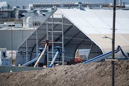 Amid "production hell," Tesla built a gigantic tent outside its Fremont, Calif. headquarters for Model 3 manufacturing overflow. Photo: David Paul Morris/Bloomberg/Getty